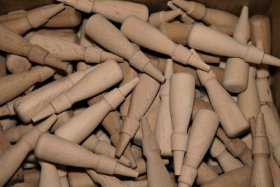 Bulk Wood Handle Production on Automated Lathes for Large-Scale Manufacturing Rows of custom wood handles produced in bulk using automated lathes for high-volume manufacturing.