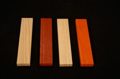 Four wood mouldings in different profiles and stained finishes, displayed side by side.