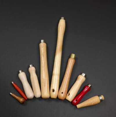 Assorted custom wood tool handles in different lengths and profiles, shown with various secondary operations including holes, tapers, and tenons.
