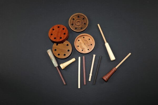 Assorted custom wooden game call barrels crafted from premium hardwoods with various finishes.