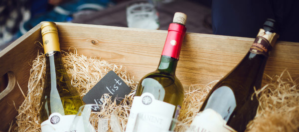 Custom Wooden Wine Boxes for Bulk Orders and Personalized Branding Three bottles of wine in a custom wooden wine box with dividers, showcasing bulk manufacturing and branding options.