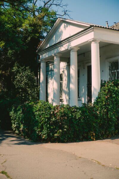 Home with White Exterior Columns Front view of a home with white-painted exterior wood columns supporting a covered porch.