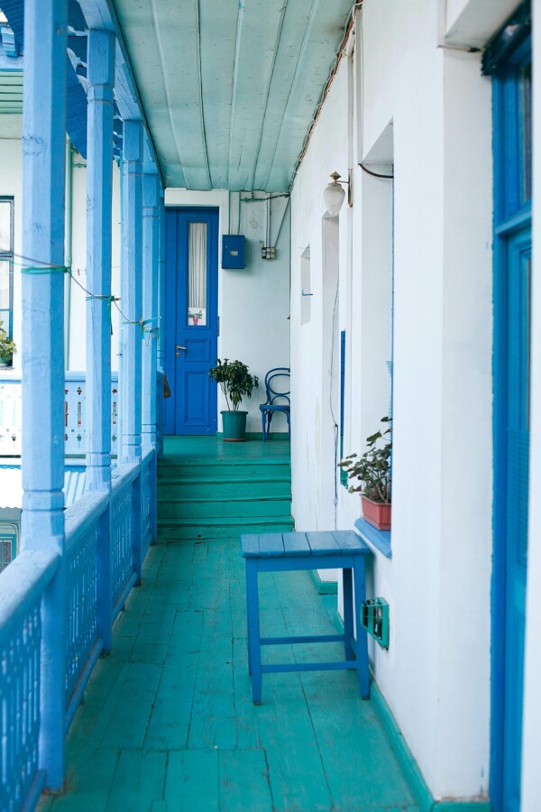Painted wood deck with blue floorboards, posts, and railings.