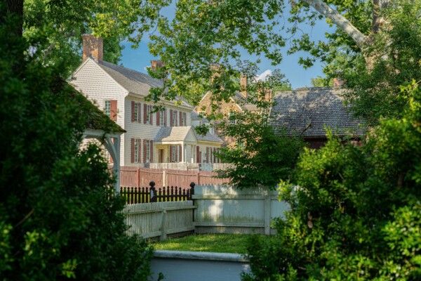 Exterior of Historic Colonial Home with Symmetrical Design Historic Colonial home exterior with symmetrical windows, wood siding, and shutters.