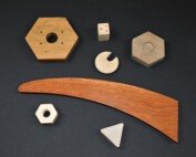 Custom-shaped wooden components designed for bulk manufacturing with varied profiles and machining styles.