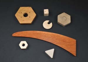 Custom-shaped wooden components designed for bulk manufacturing with varied profiles and machining styles.
