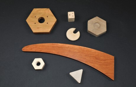Custom-shaped wooden components designed for bulk manufacturing with varied profiles and machining styles.