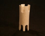 A small wooden knitting tower with intricate turning and routed details.