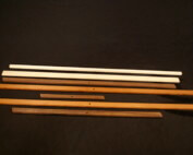 Stacked custom wood mouldings in assorted profiles for large-scale manufacturing projects.