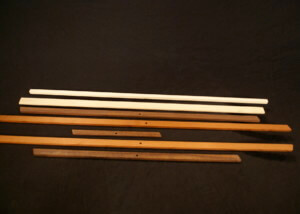 Stacked custom wood mouldings in assorted profiles for large-scale manufacturing projects.