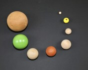 Assorted wooden balls and beads in multiple sizes with drilled holes and flat routing for custom applications.