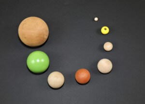 Assorted wooden balls and beads in multiple sizes with drilled holes and flat routing for custom applications.
