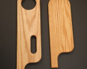 Custom-shaped wood chair arms CNC routed for furniture manufacturing applications.