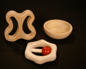 Three custom CNC-routed wood components shaped for use as toy parts, brush blocks, or tool handles.