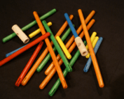 Pile of custom finished wooden dowels and toy parts made to specification.