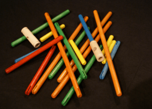 Pile of custom finished wooden dowels and toy parts made to specification.