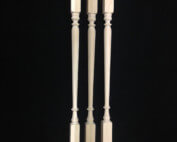 Three custom interior wood balusters turned in different profiles for residential staircases.