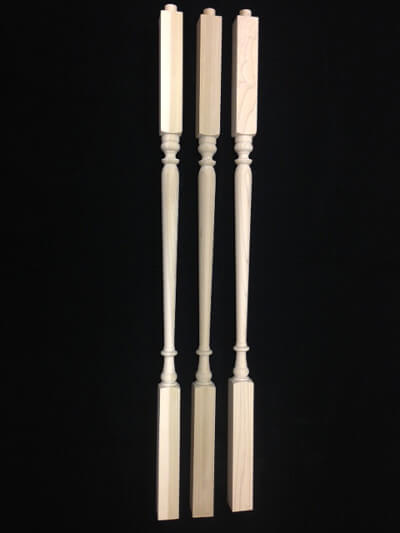 Custom Interior Wood Balusters for Staircases and Architectural Projects Three custom interior wood balusters turned in different profiles for residential staircases.