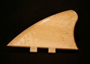 One custom-shaped wooden component designed for surfboard or specialty product applications.