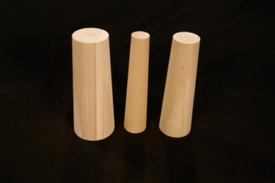 Three custom tapered wooden plugs in different sizes for industrial sealing and manufacturing use.