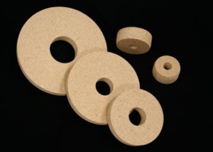 Five round wooden core plugs in various sizes made from particle board.