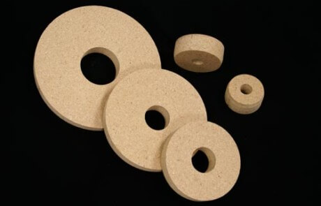 Five round wooden core plugs in various sizes made from particle board.