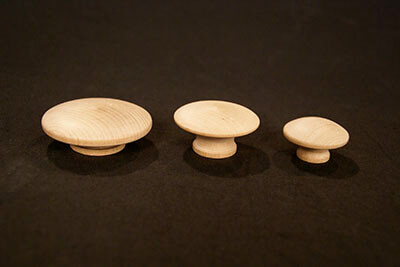 Custom Wood Drawer Pull Knobs in Bulk for Furniture and Cabinet Manufacturing Three different-sized wooden drawer pull knobs in a classic mushroom shape, made from natural wood.