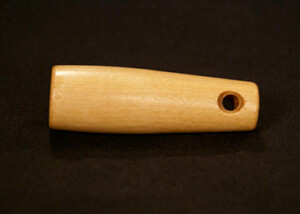 Turned wood handle featuring a clean countersunk crossbore hole for hanging or strap attachment.