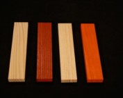 Four wood mouldings in different profiles and stained finishes, displayed side by side.