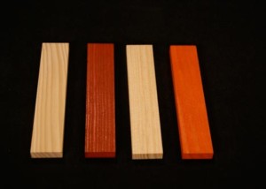 Four wood mouldings in different profiles and stained finishes, displayed side by side.