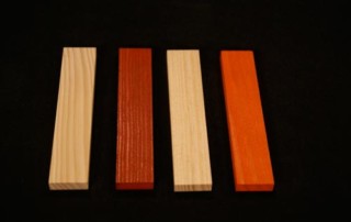 Four wood mouldings in different profiles and stained finishes, displayed side by side.