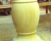 Custom turned wooden pedestal column for supporting tables, kitchen islands, or architectural elements.