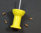 Large and small custom wooden push pin barrels shown side by side on a wooden surface.