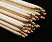 Bundle of custom wooden skewers with pointed ends stacked for shipment.