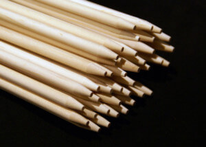 Bundle of custom wooden skewers with pointed ends stacked for shipment.