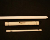 Assorted wood dowels and turned components featuring secondary operations such as holes, tapers, and tenons.