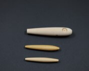 Three unfinished wooden fishing lure bodies designed for custom tackle production.