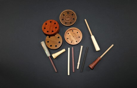 Assorted custom wooden game call barrels crafted from premium hardwoods with various finishes.