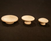 Three unfinished wood knobs in different sizes for drawer and cabinet applications.