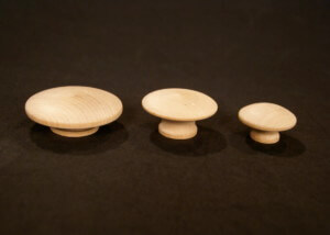 Three unfinished wood knobs in different sizes for drawer and cabinet applications.