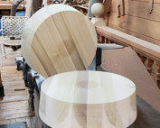 Two large diameter wooden plugs on concrete surface, used in custom municipal and industrial applications.