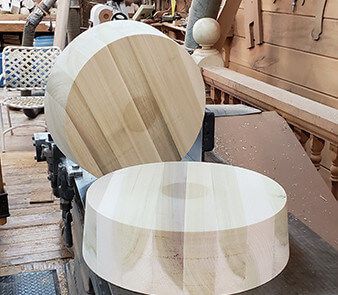 Two large diameter wooden plugs on concrete surface, used in custom municipal and industrial applications.