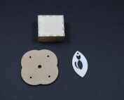 Assorted laser-cut wood parts with various shapes and cutouts for bulk manufacturing applications.