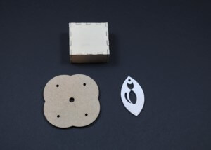 Assorted laser-cut wood parts with various shapes and cutouts for bulk manufacturing applications.