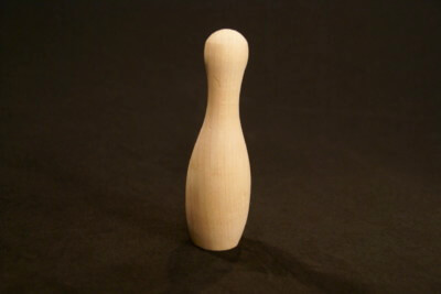 Mini wooden bowling pin made to custom specifications for bulk manufacturing and children's games.