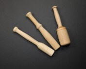 Three custom wooden muddlers in different shapes made from natural hardwood.