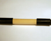 Custom wooden dowel featuring end caps and drilled holes, manufactured for bulk and specialty applications.