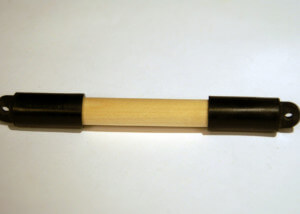 Custom wooden dowel featuring end caps and drilled holes, manufactured for bulk and specialty applications.