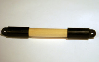 Custom wooden dowel featuring end caps and drilled holes, manufactured for bulk and specialty applications.