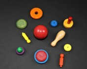 Assorted custom-painted wooden turnings in bright colors made for bulk orders and safety-compliant uses.